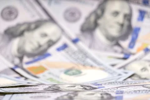 Blurred. Background full of 100 us dollars. Business and finance. Shallow depth Stock Photos