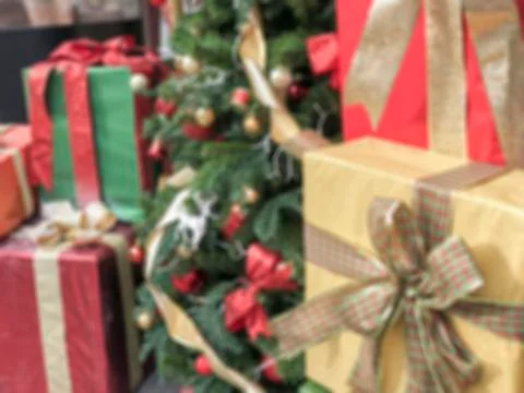 Blurred background with gift boxes and noel tree Stock Photos
