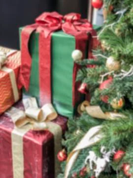 Blurred background with gift boxes and noel tree Stock Photos