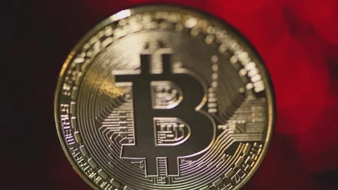 Blurred background. Golden bitcoin close-up  on a blurry red background Stock Footage 151479025