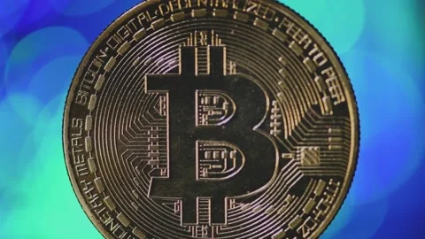 Blurred background. Golden bitcoin close-up  on a blurry blue-green background Stock Footage 151571061