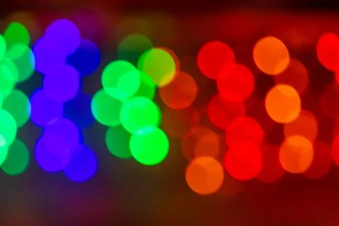 A blurred background with a group of multi colored blue, green, red circles f Stock Photos