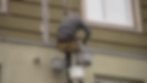 Blurred background. High-altitude work. The man works on high-rise works Video stock 134905780