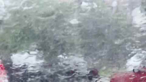 Blurred background image of raindrops on a glass surface, heavy rain. Stock Footage 212405302