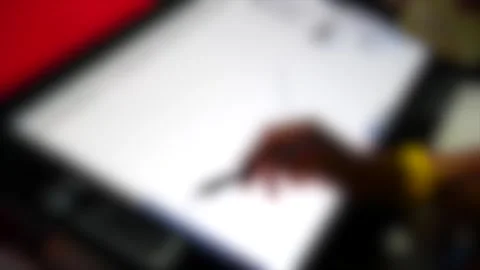 Blurred background. The man with his hand with special pencil drawing on tablet Stock Footage 137669482