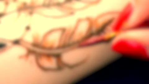 Blurred background. Mehendi, Henna application process, painting mehendi, Stock Footage 135857185