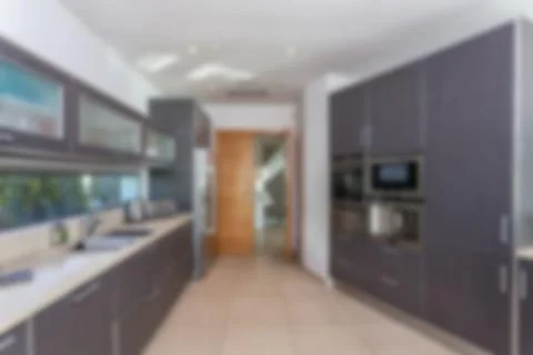 Blurred background of modern kitchen. Stock Photos