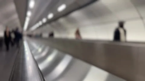 Blurred background of moving travelator with blurred people commuting Stock Footage 344984397