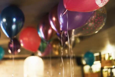 Blurred background with multicolored balloons under the ceiling. Festive concept Stock Photos