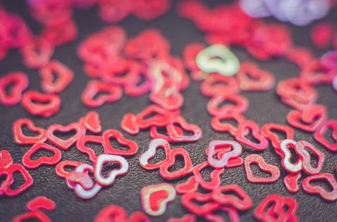 Blurred background of multicolored hearts with selective focus. Stock Photos