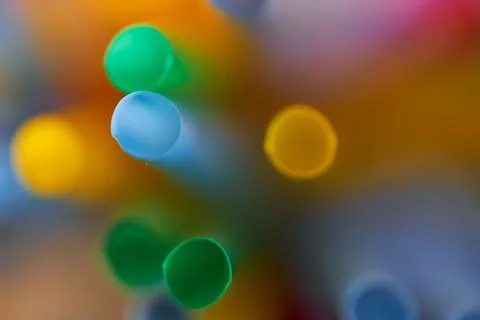 Blurred Background Multicolored Plastic Drinks Tubes. Close-up. Stock Photos