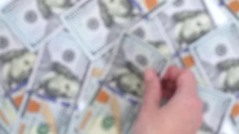 Blurred background of multiple hundred dollar bills stacked together. The image Stock Footage 311136133
