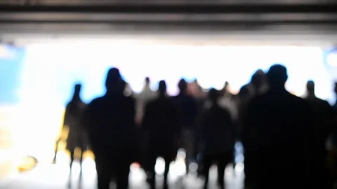 Blurred background. People come to light from an underground passage Stock Footage 91816962
