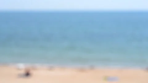 Blurred background People resting sunbathing sandy beach sea shore near calm Stock Footage 296121823