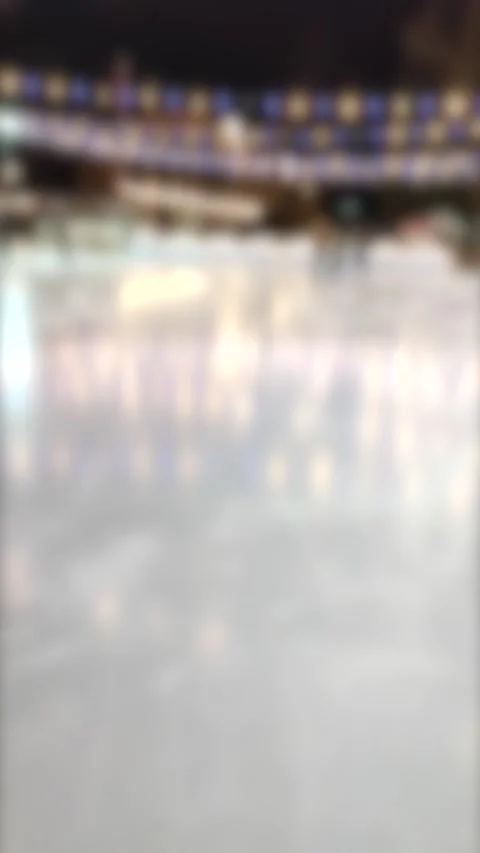 Blurred background. People skating on public open-air ice skating rink in city Stock Footage 218588663