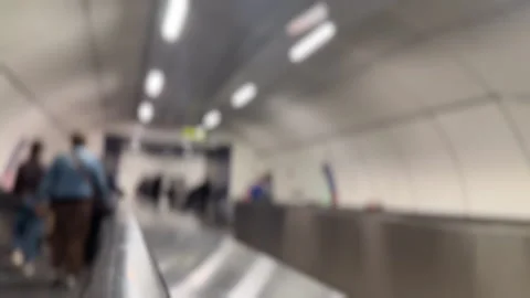 Blurred background of people walking on moving travelator Stock Footage 344983766