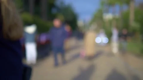 Blurred background. people walking in the park along the alley on a sunny day Stock Footage 146026682