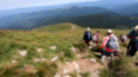 Blurred background. Person go down mountain. People walk on dirt mountain trail Stock Footage 142526511