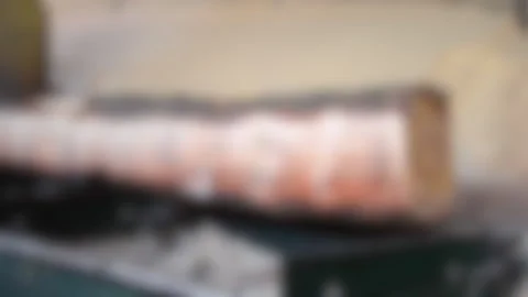 Blurred background. Process of machining logs in equipment sawmill machine saw Stock Footage 138004382