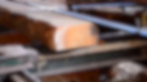 Blurred background. Process of machining logs in equipment sawmill machine saw Stock Footage 138006412