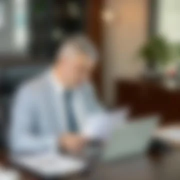 Blurred Background of Senior Executive Working at Office Desk Stock-Fotos