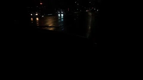 Blurred background showing traffic rainy night highway, with cars traffic light 스톡 동영상 345516825