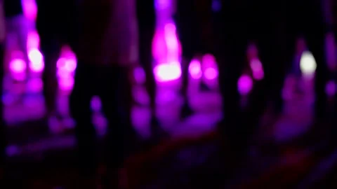 Blurred background of silhouettes of crowd people dancing at night party. Vidéo 134737344