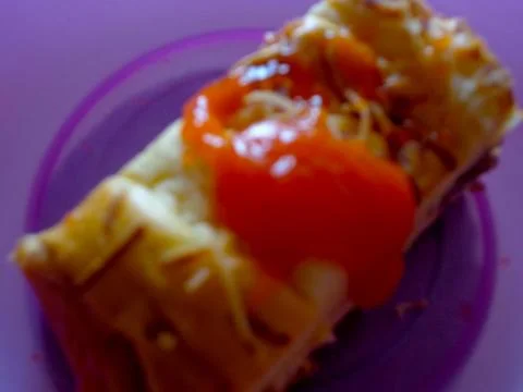 A blurred background of a slice of breakfast bread topped with cheese and sauce Stock Photos
