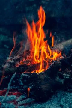 Blurred background. Small flame dying fire, bright red-orange flame. Cozy war Stock Photos