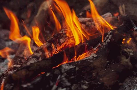 Blurred background. Small flame dying fire, bright red-orange flame. Cozy war Stock Photos