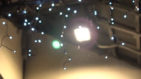 Blurred background with small snowflakes falls on against the light of a street 스톡 동영상 146437006