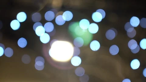 Blurred background with small snowflakes falls on against the light of a street Stock Footage 146506987