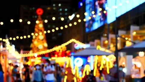 Blurred Background with Sparkling Christmas Tree and People in Face Masks Stock Footage 160637455