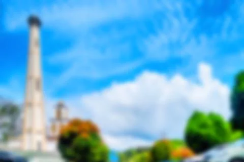Blurred background of a tall tower or mosque minaret Фото