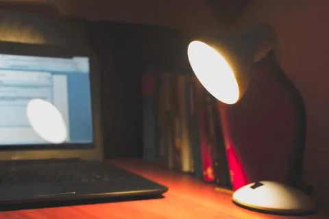 Blurred background on the theme of study, table lamp on the background of boo 写真素材