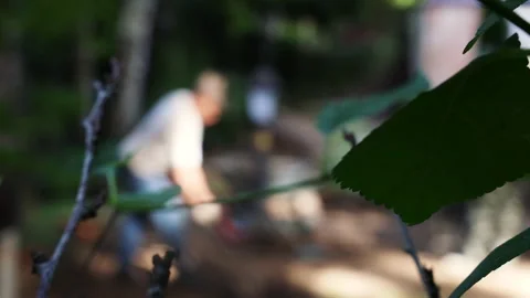 Blurred background, view of a Tajik worker driving a wheelbarrow with sand in th Stock Footage 279333459