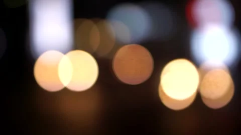 Blurred background with warm bokeh lights in a nighttime atmosphere. 库存影片 333728040