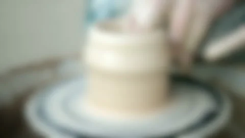 Blurred background. Workshop Molding of clay on a potter's wheel Stock Footage 140300831