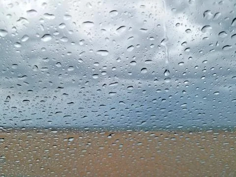 Blurred beach background with raindrops Stock Photos