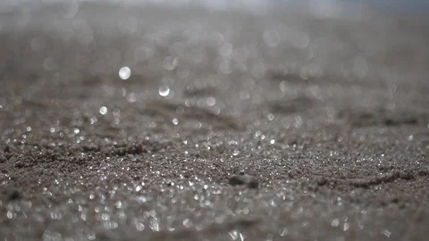 Blurred beach sand, close up panning shot abstract low angle view Stock Footage 100168181