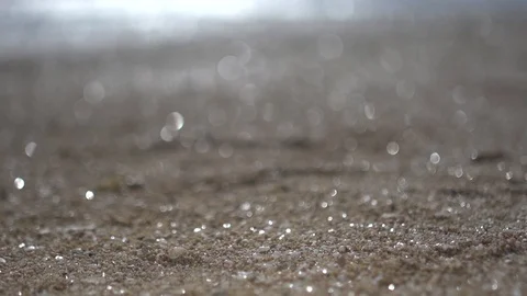 Blurred beach sand, close up panning shot abstract low angle view Video stock 100169313