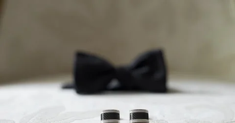 Blurred black bow tie on a white surface Vídeo Stock 336472649