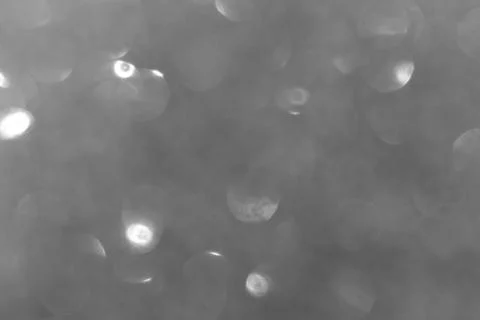 Blurred black glitter texture background photo. Blur black shining glowing bo Stock Photos