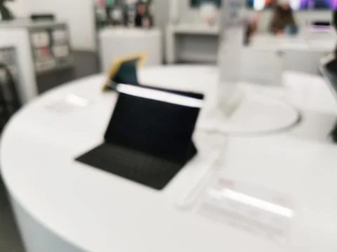 Blurred black tablet on a round white table Photos