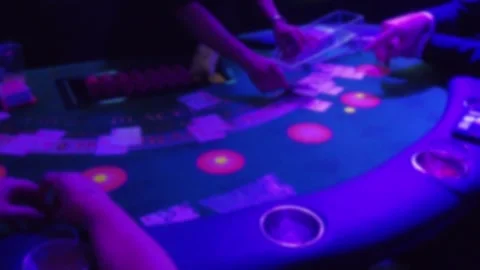 Blurred Blue And Green Blackjack Table With Strobe Lights As Dealer Deals Ca Stock Footage 252151331