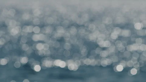Blurred blue Bokeh ocean waves abstract background focus flickering Stock Footage 345008081