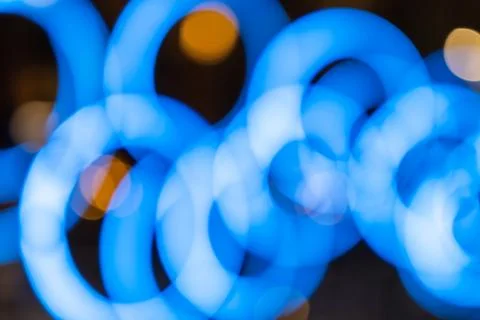Blurred blue circular lights creating a bokeh effect Stock Photos