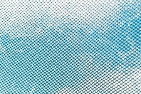 Blurred blue sky with clouds visible through metal fine mesh Stock Photos