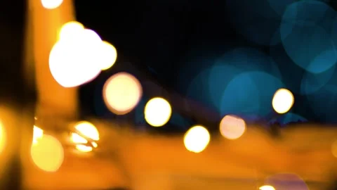 Blurred bokeh background of cafe string lights and white light bubbles Stock Footage 243099024