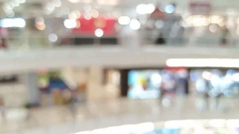 Blurred bokeh defocused background of large void inside Interior of a mall Video stock 147111674